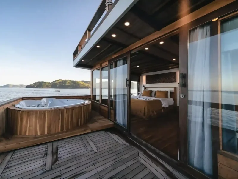 Master suite with private balcony and jacuzzi on a luxury phinisi in Komodo National Park