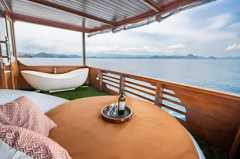 An open-air bathtub and table on the deck of a charter boat