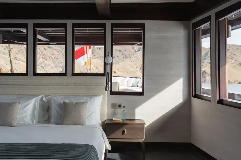 An air-conditioned cabin with sea-facing windows aboard a Komodo liveaboard