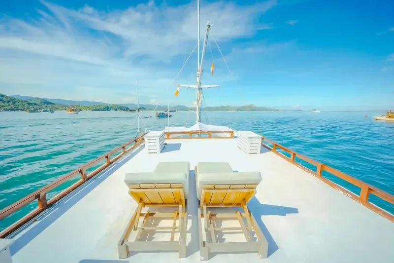 Sun loungers on the bow of a charter boat in Komodo
