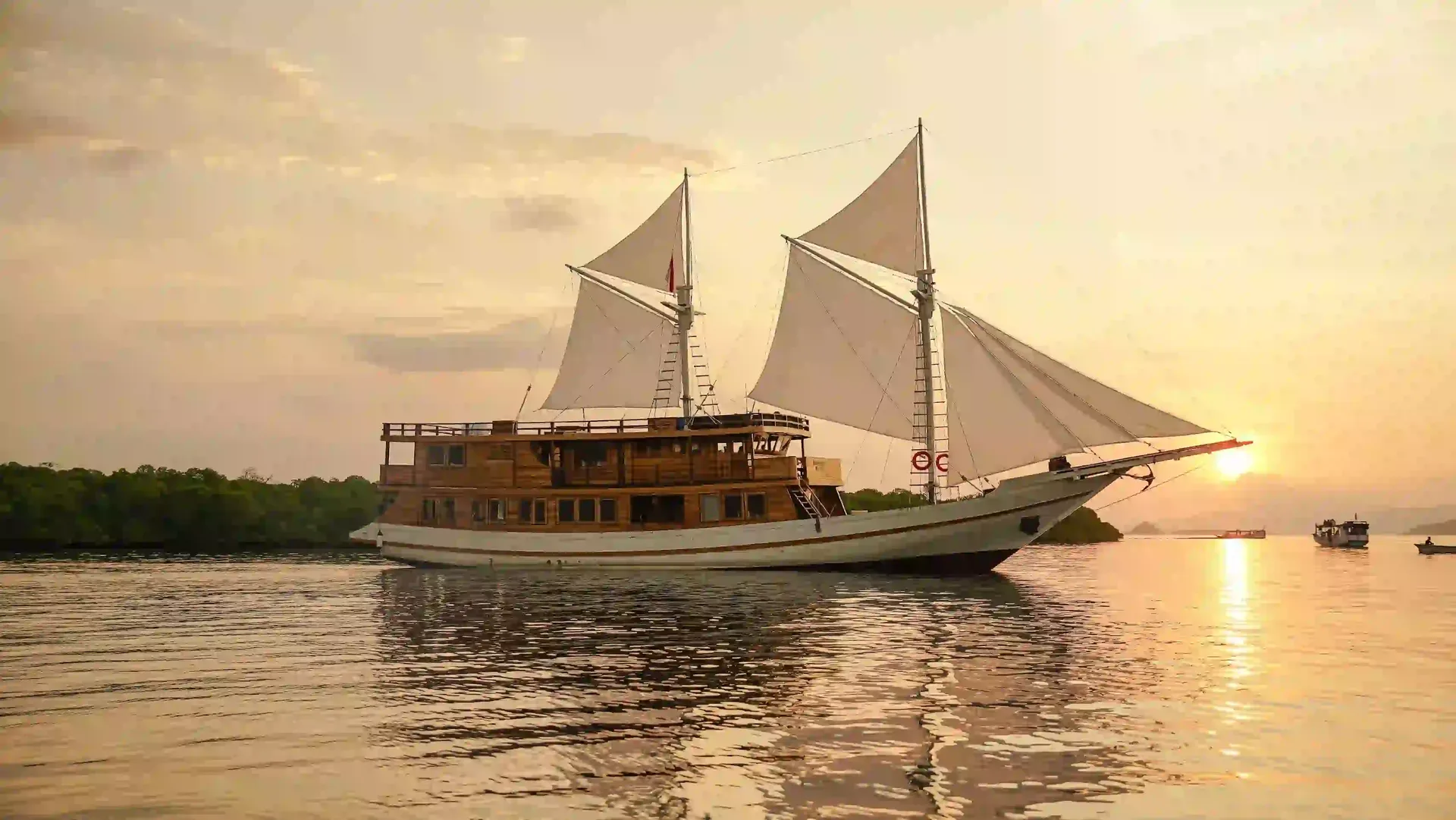 A phinisi at anchor in golden light, Komodo National Park