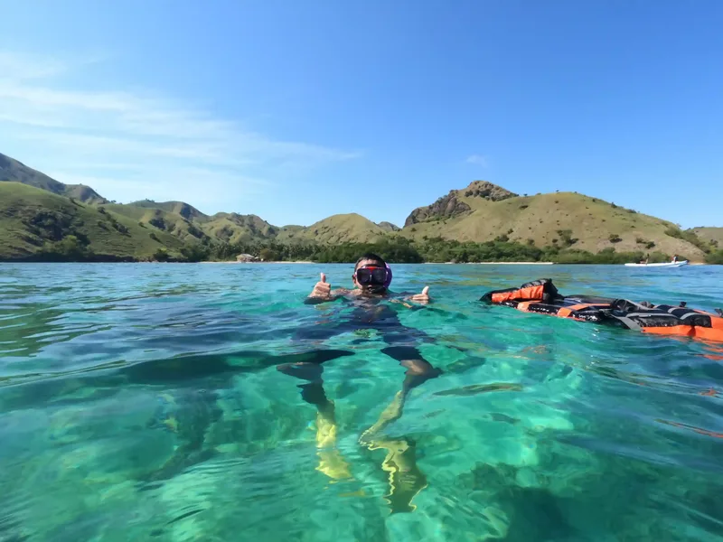 Snorkellers in the turquoise shallows of Komodo National Park