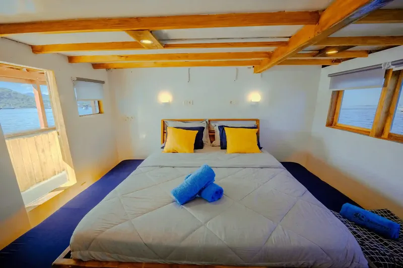 A timber-lined double cabin aboard a phinisi